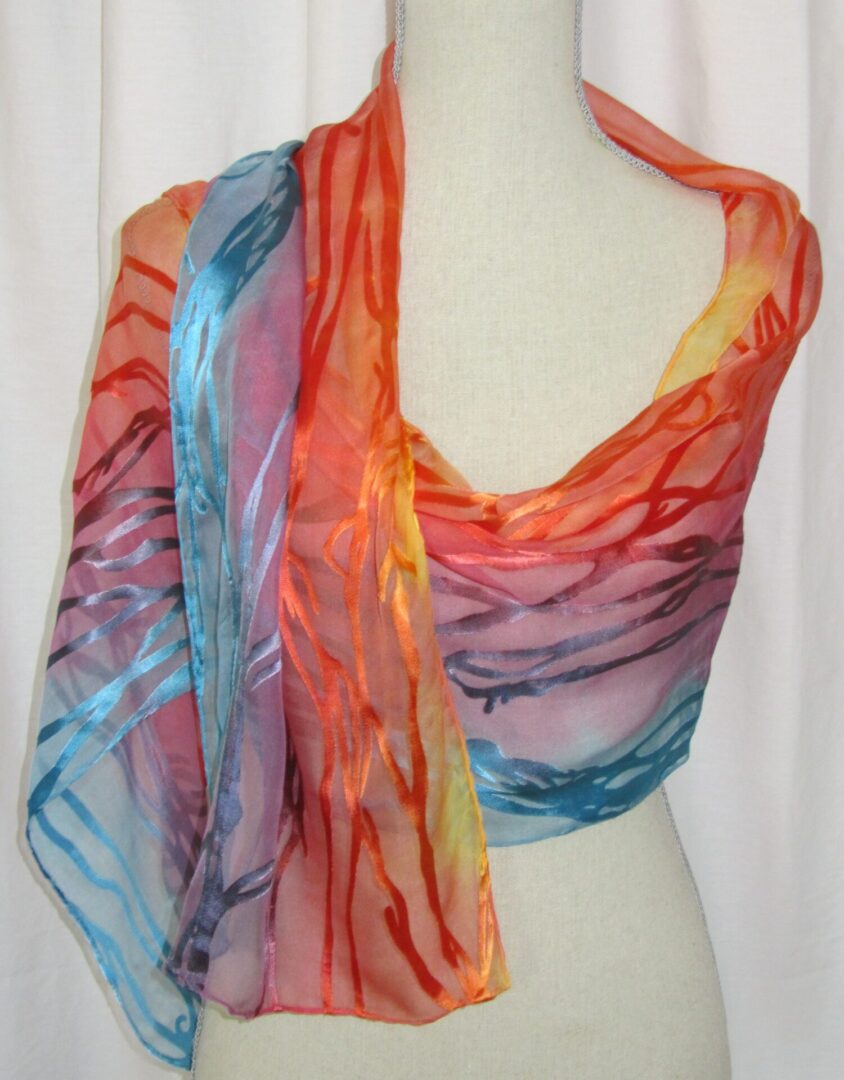 A colorful scarf with a multi colored design.