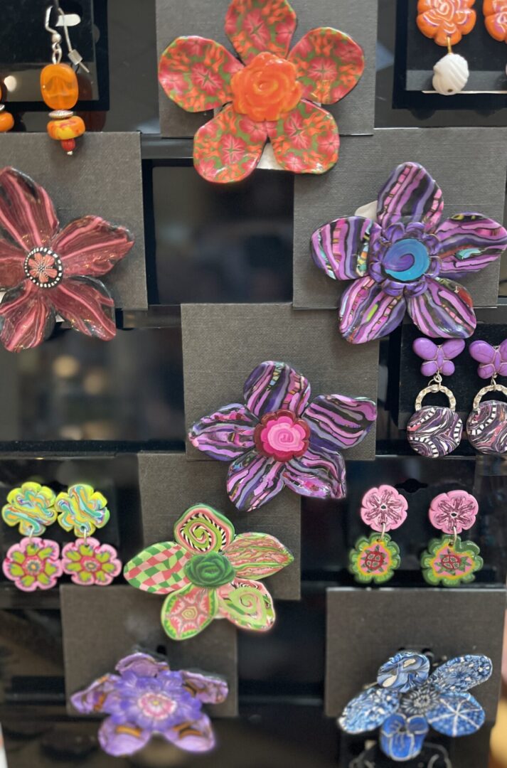 A display of colorful flower earrings on display.
