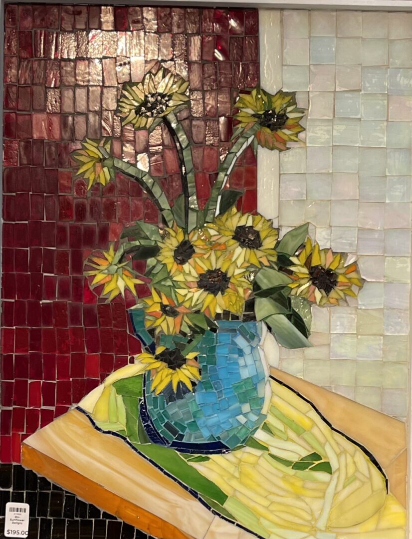 A vase of sunflowers in a blue vase on a table.
