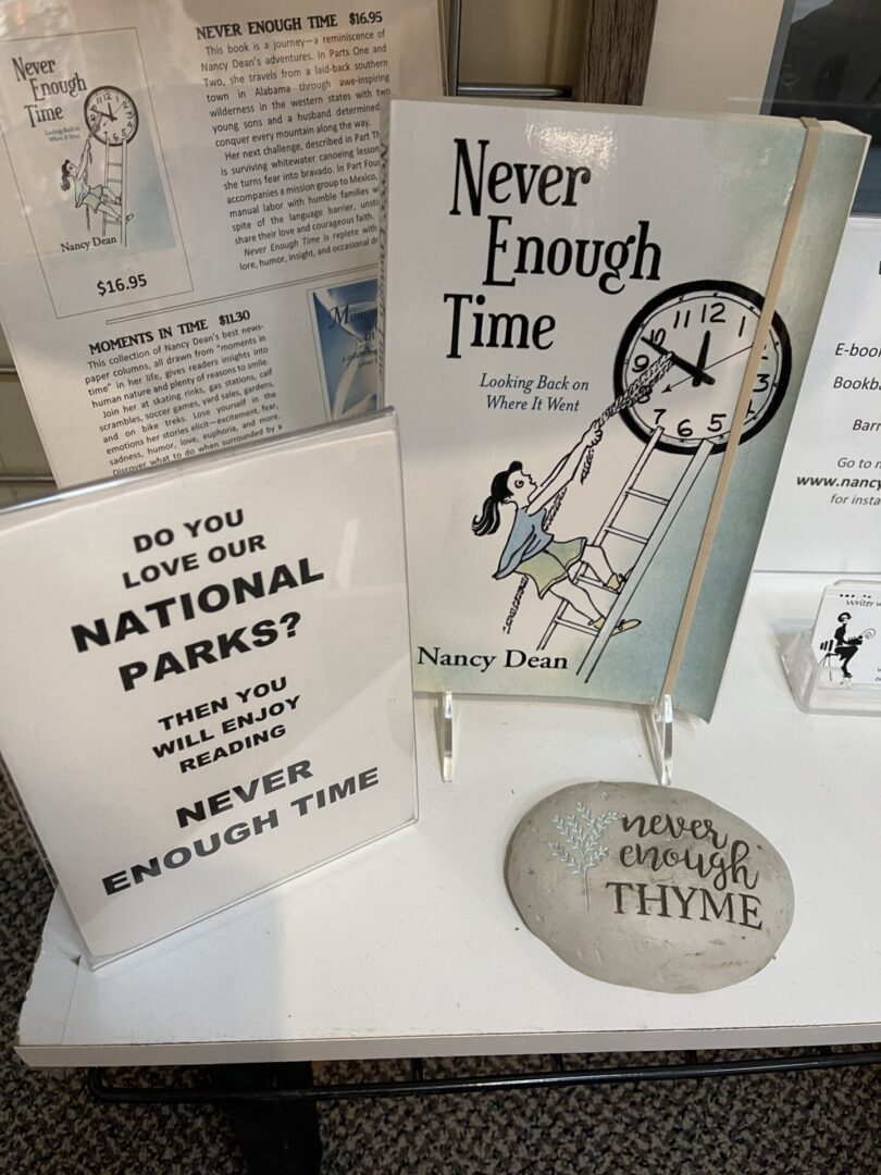 A display of books and a clock on a table.