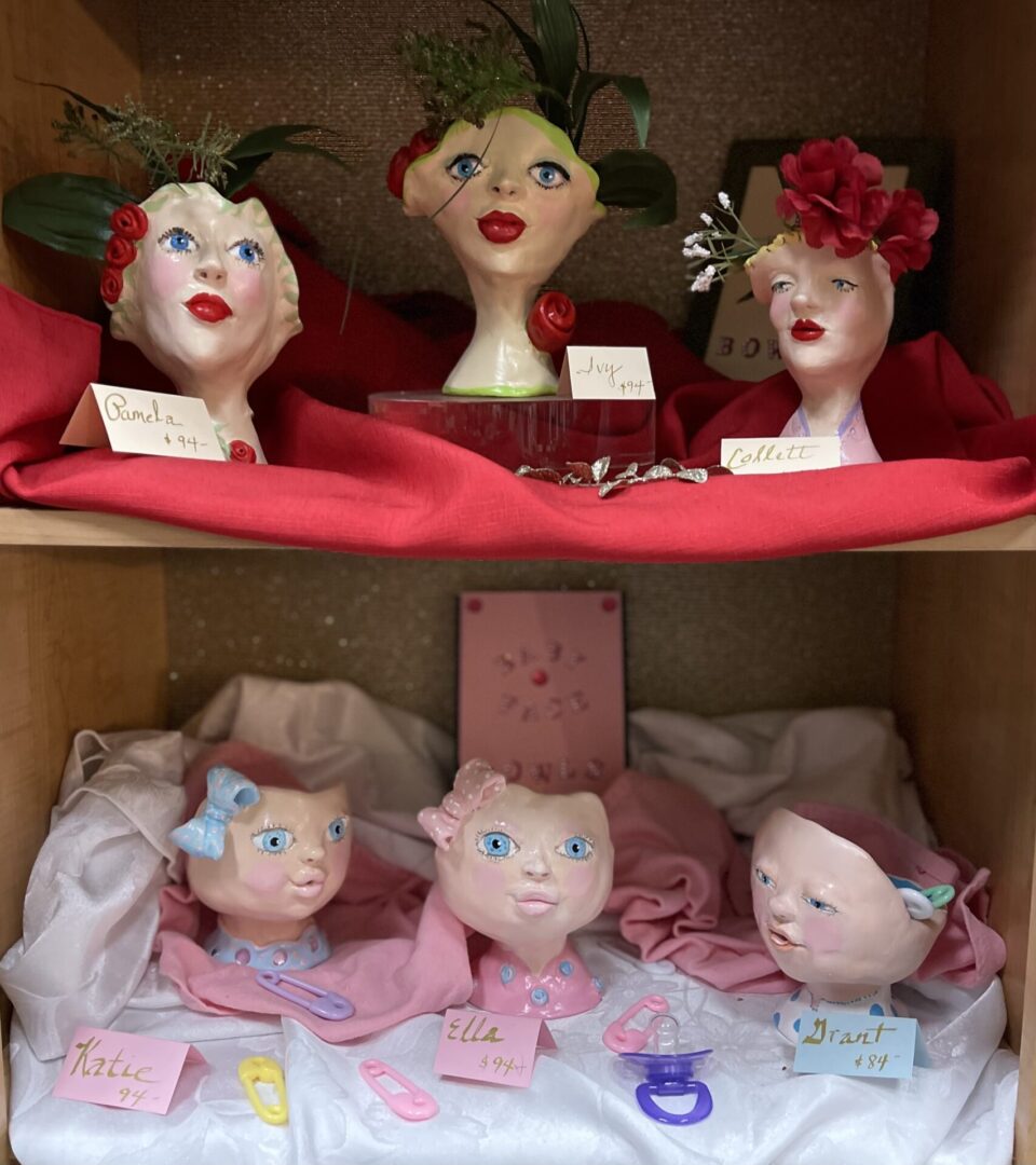 A display of ceramic figurines on a shelf.