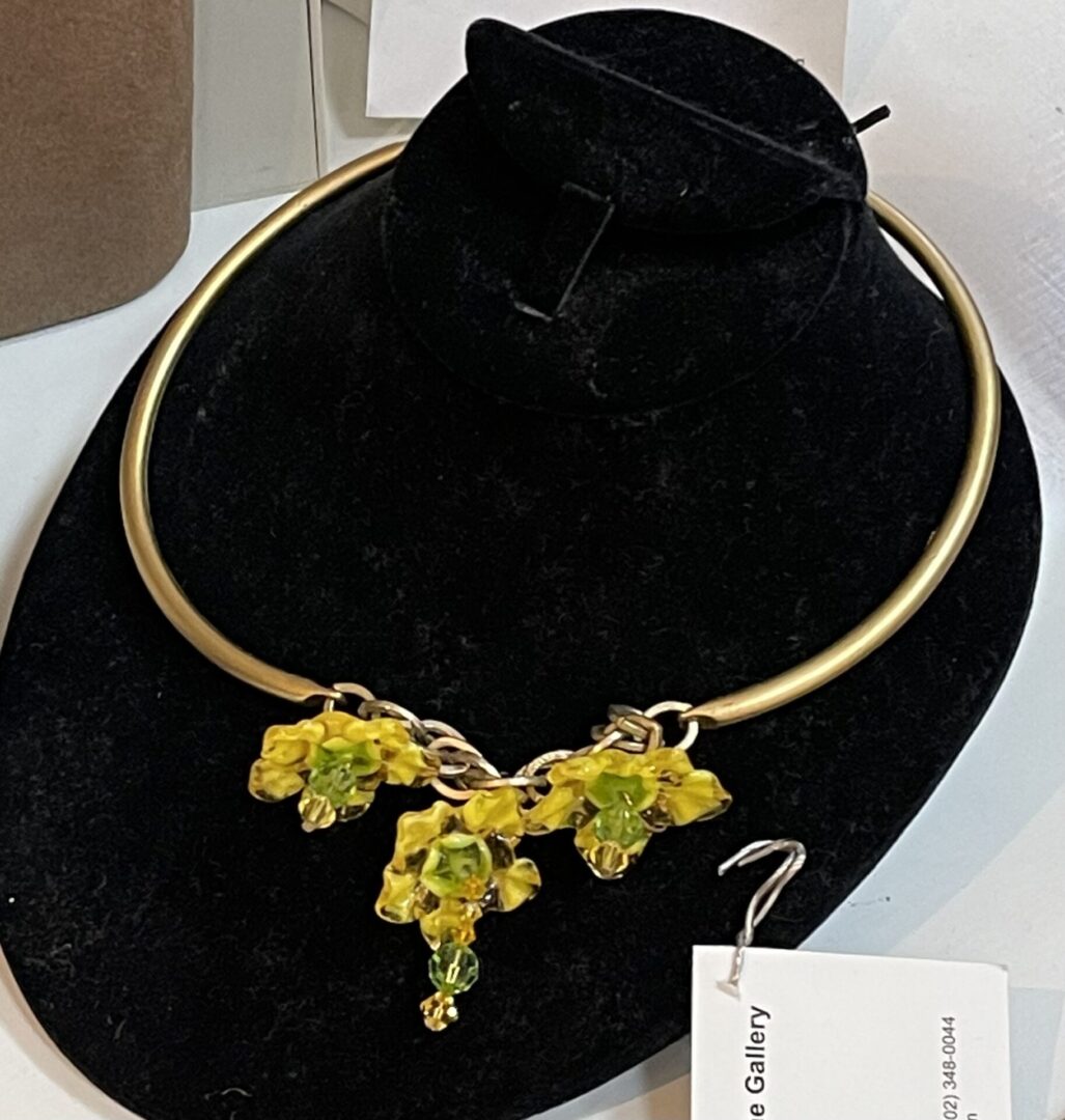 A necklace with yellow flowers on display.