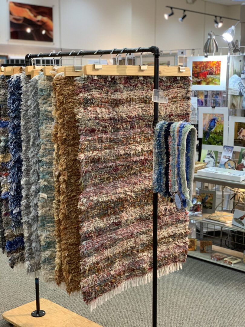 A display of colorful rugs in a store.