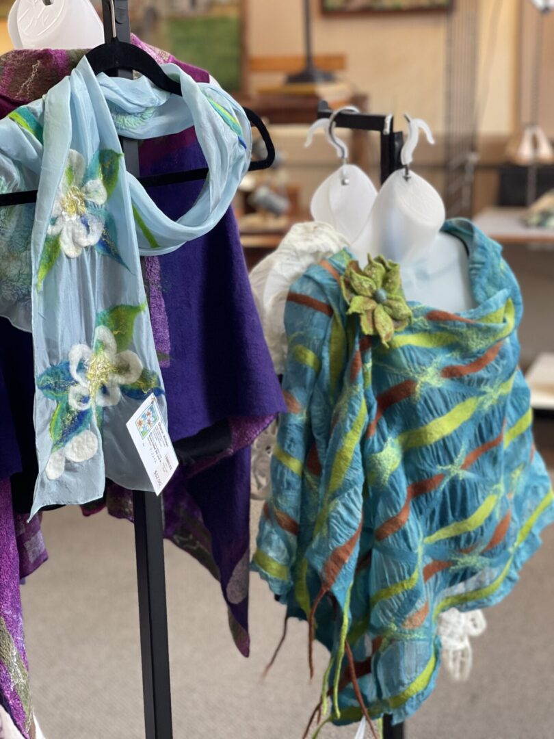 Shawls and scarves on display in a store.