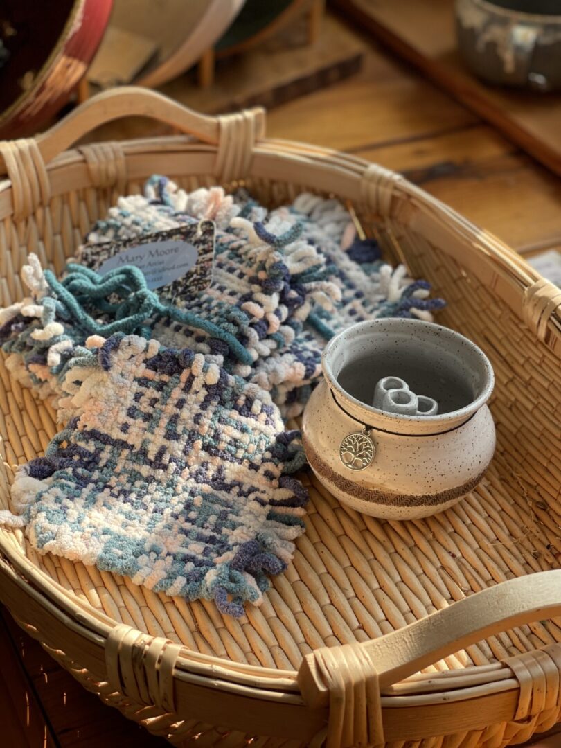 A wicker basket with a cup and a bowl on it.