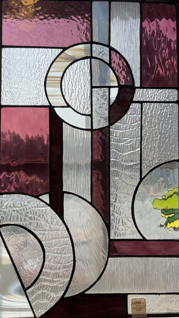 A stained glass window with a frog on it.