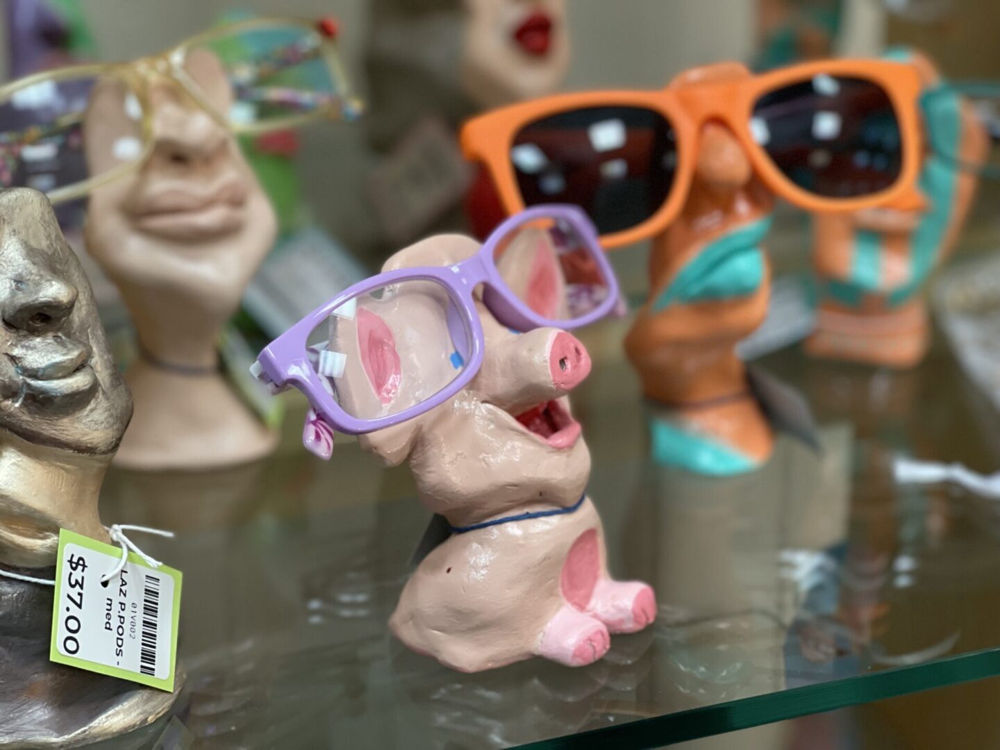 A display of figurines with sunglasses on display.