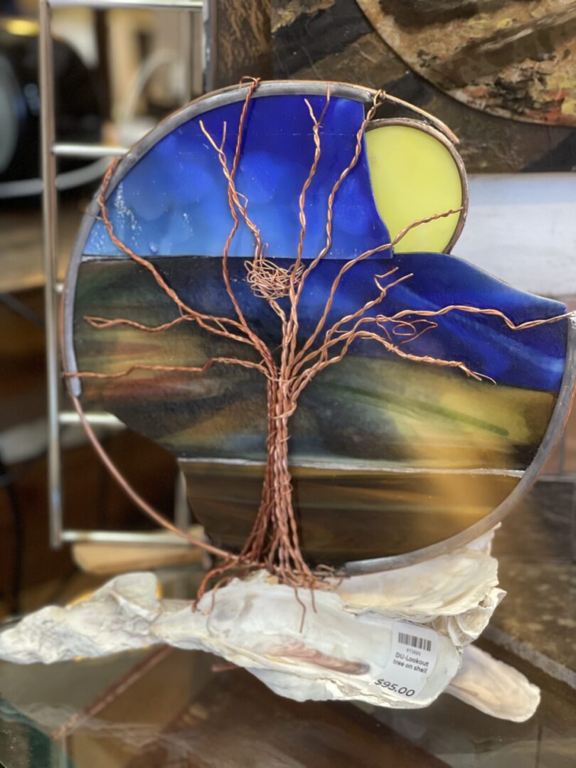 A stained glass tree on display in a store.