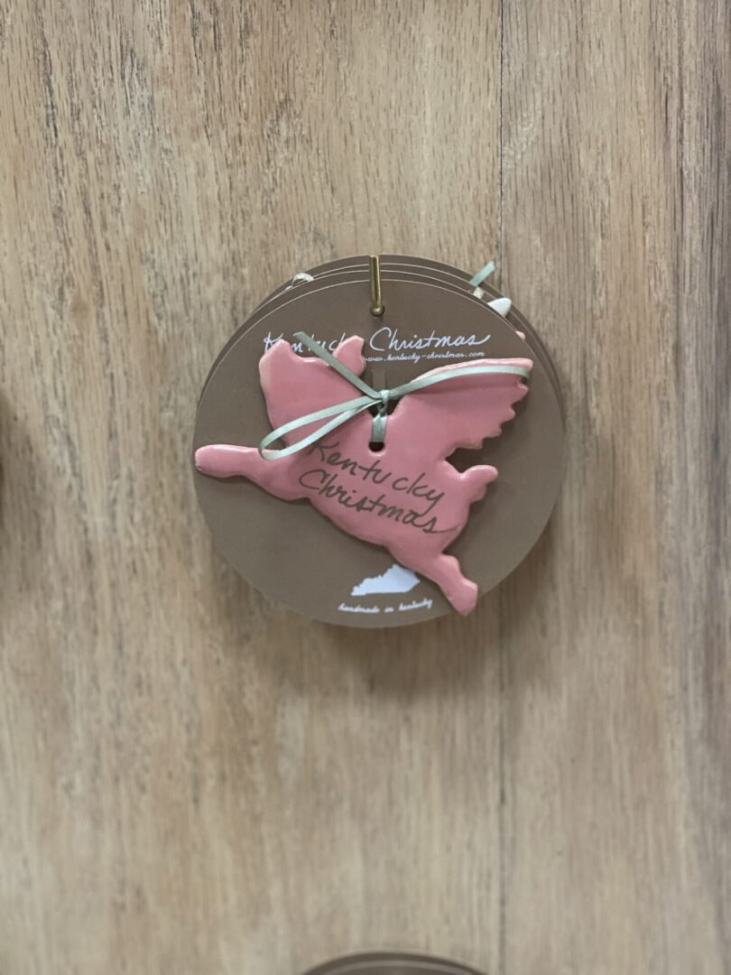 A set of pink and brown ornaments on a wooden wall.