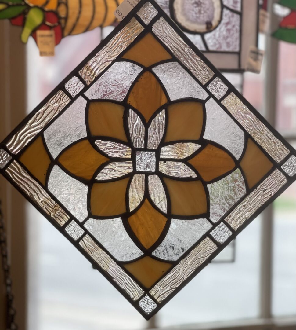 A stained glass window hanging in a window.