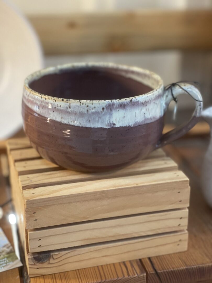 A bowl sitting on top of a wooden block.