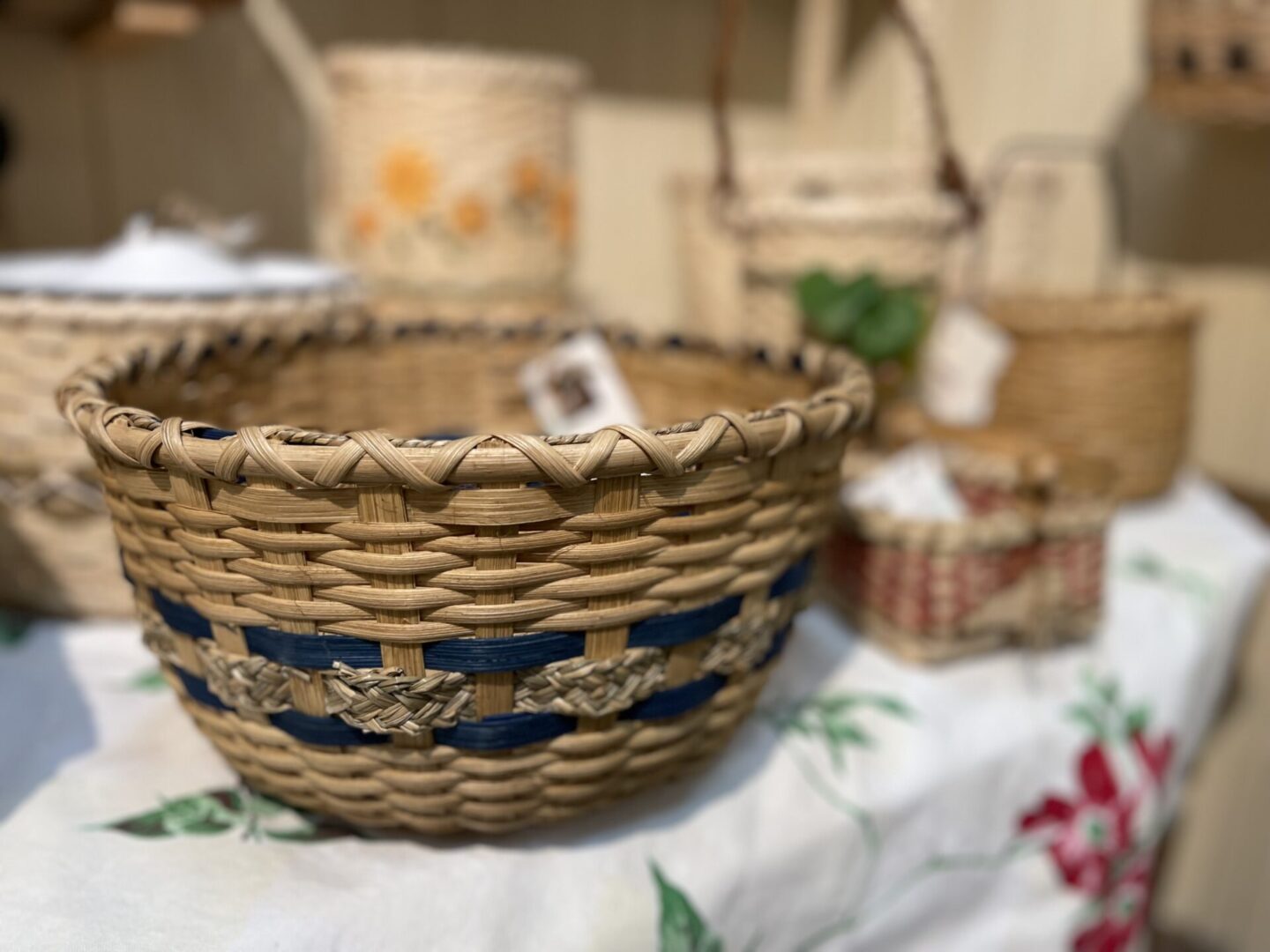 Baskets on a table next to a tablecloth.