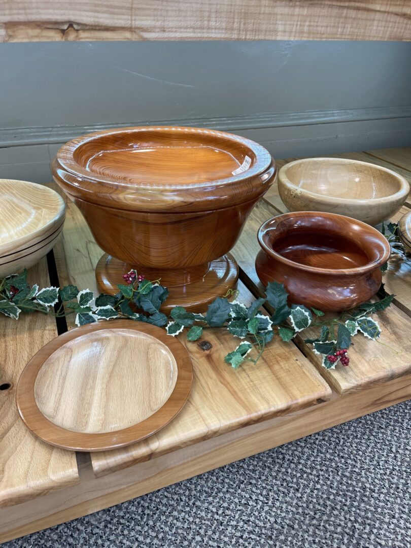 Bowls and platters on a wooden shelf.