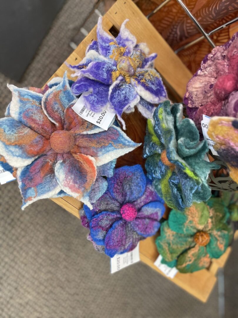 A display of felt flowers on a table.