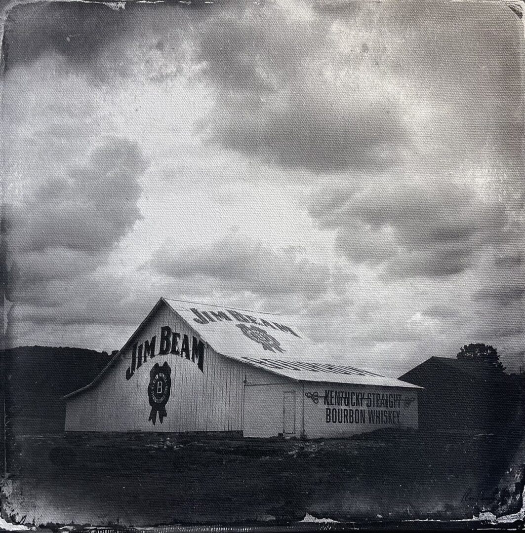 An old black and white photograph of a barn.