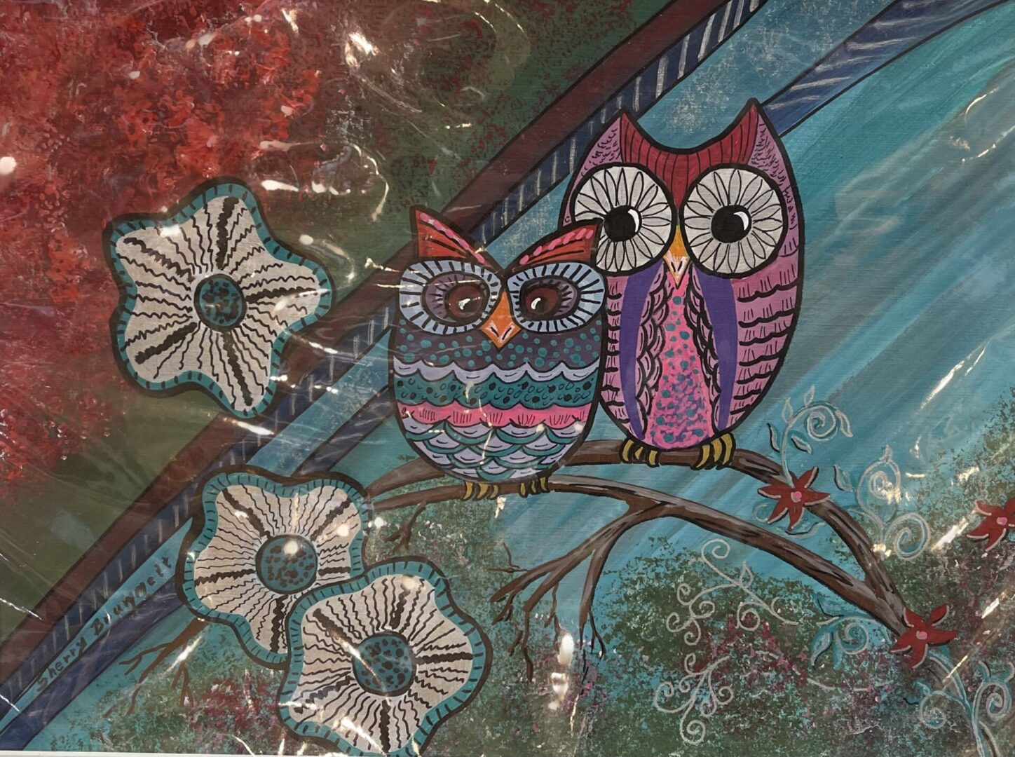 A painting of two owls sitting on a branch.
