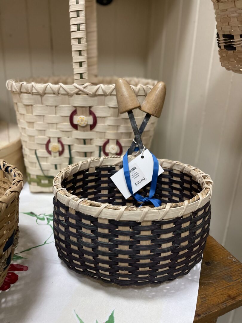 Two baskets with handles on a shelf.