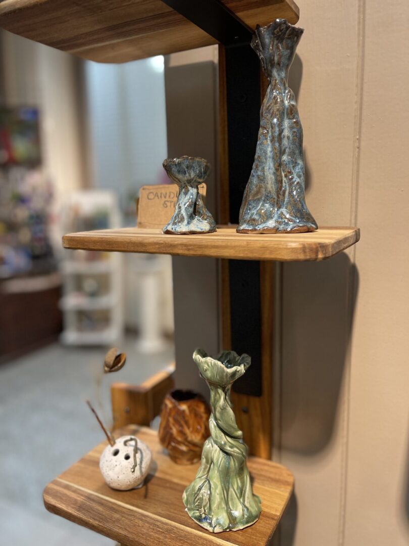 A shelf with vases and other items on it.