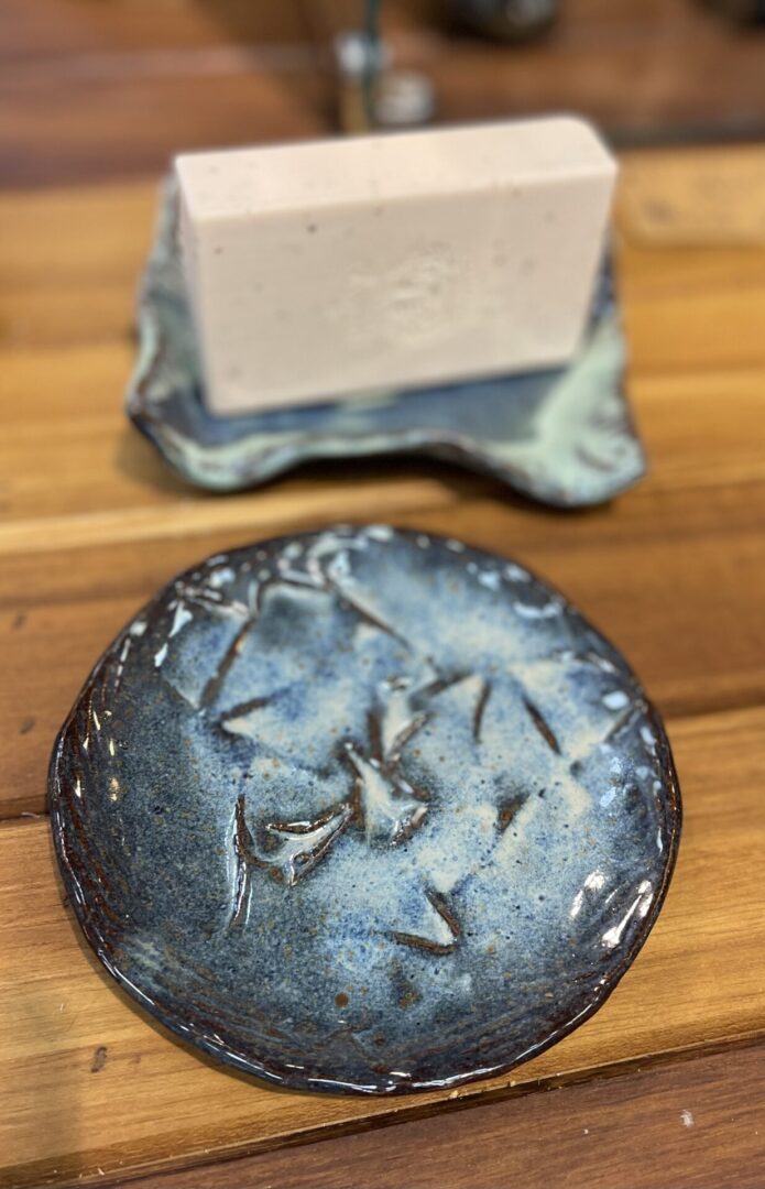 A blue plate with a soap bar on it.