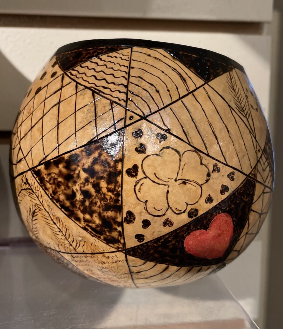 A wooden bowl with a heart on it.