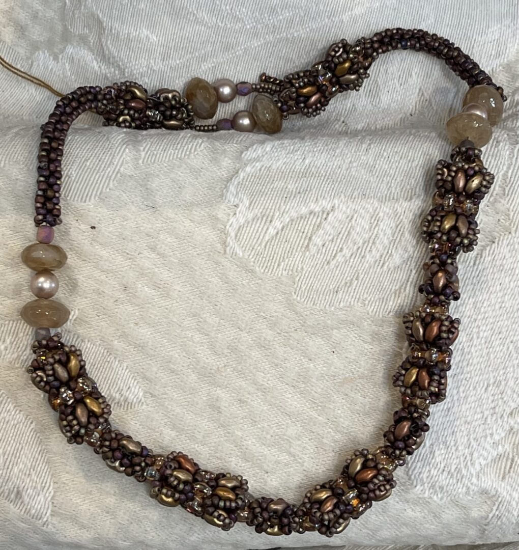 Beaded necklace with brown and gold beads.