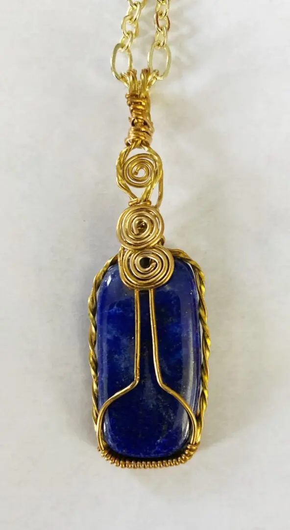 Gold wire wrapped lapis lazuli pendant.