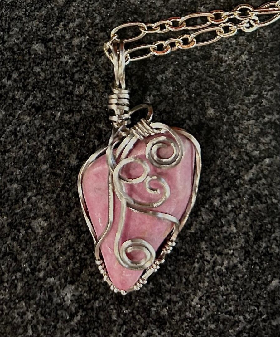 Pink stone wire wrapped pendant necklace.