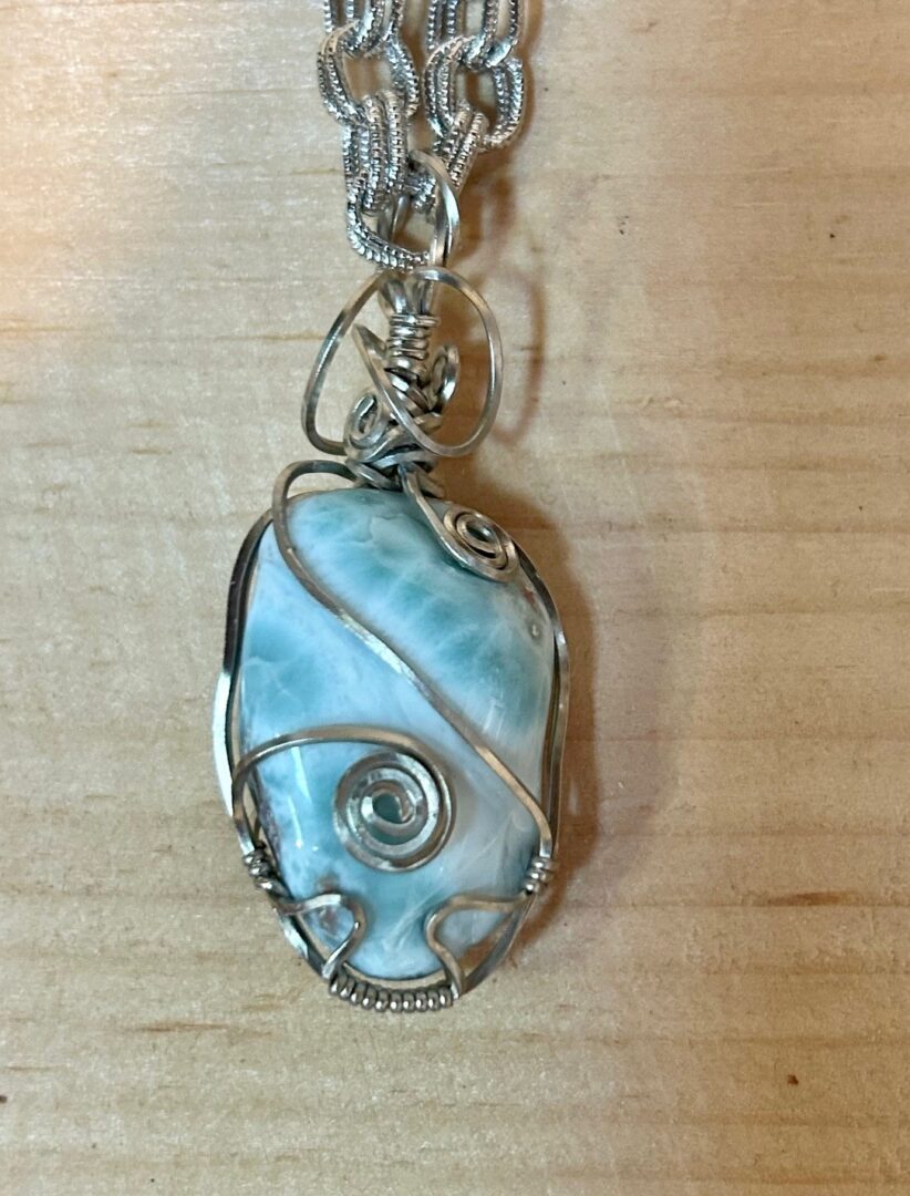 Silver wire wrapped blue lace agate pendant.