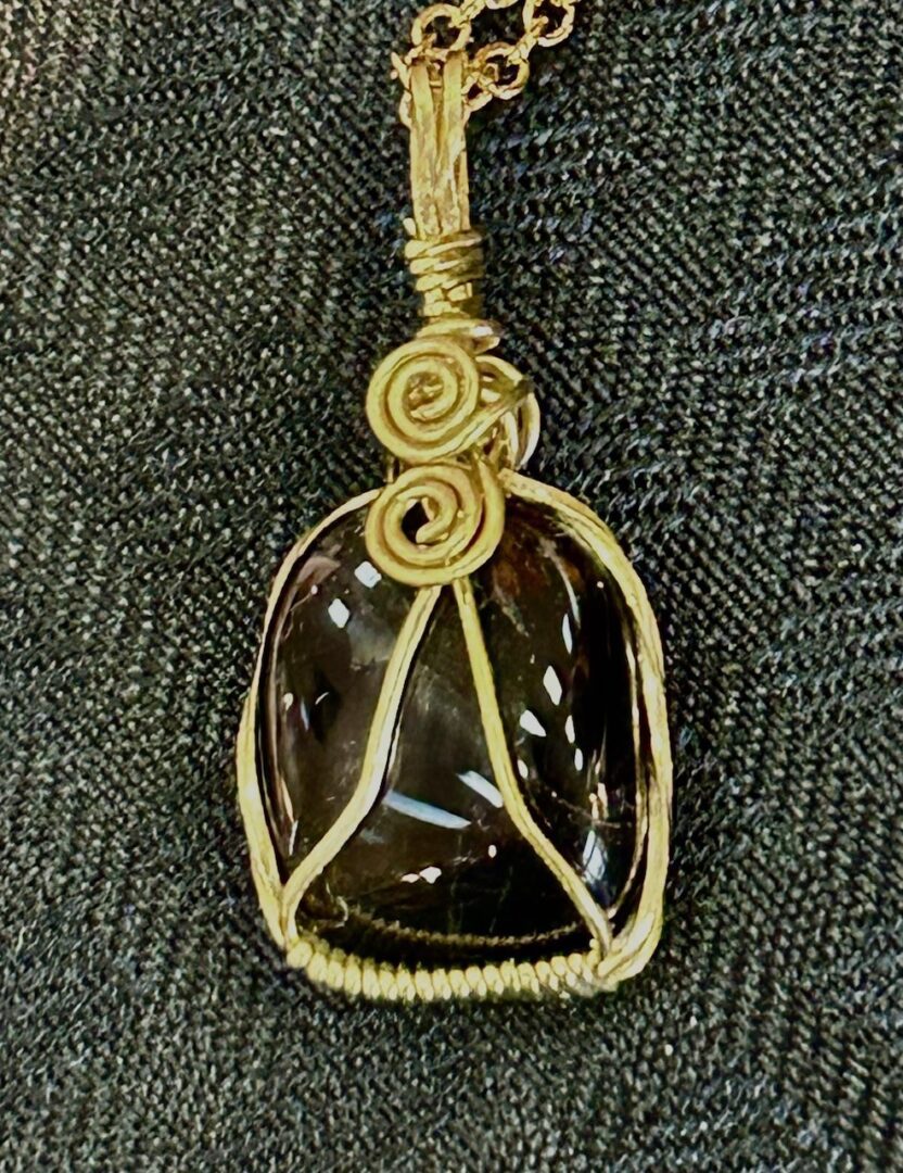 Gold wire wrapped black gemstone pendant