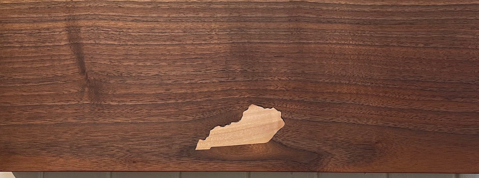 Walnut wood with a Kentucky shape cutout.