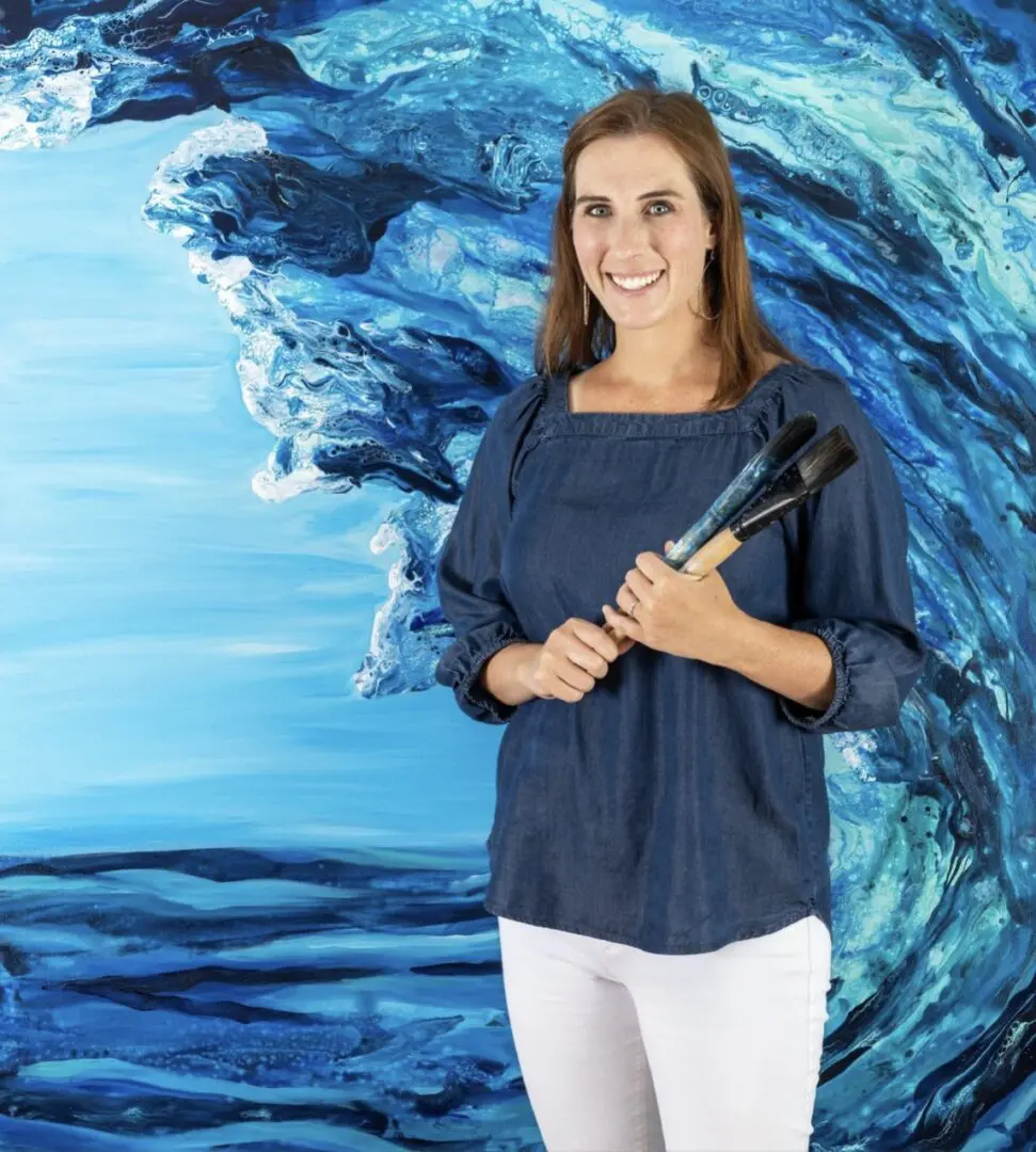 Screenshot Smiling artist with paintbrushes, ocean art.